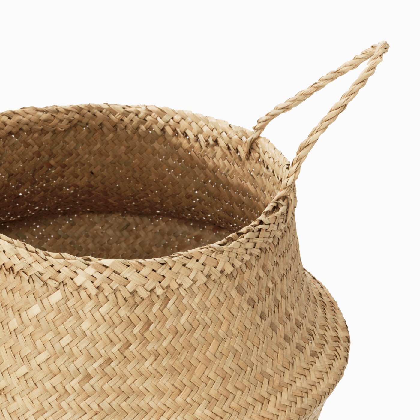 Close up of a FLÅDIS hand-woven basket against a light grey background.