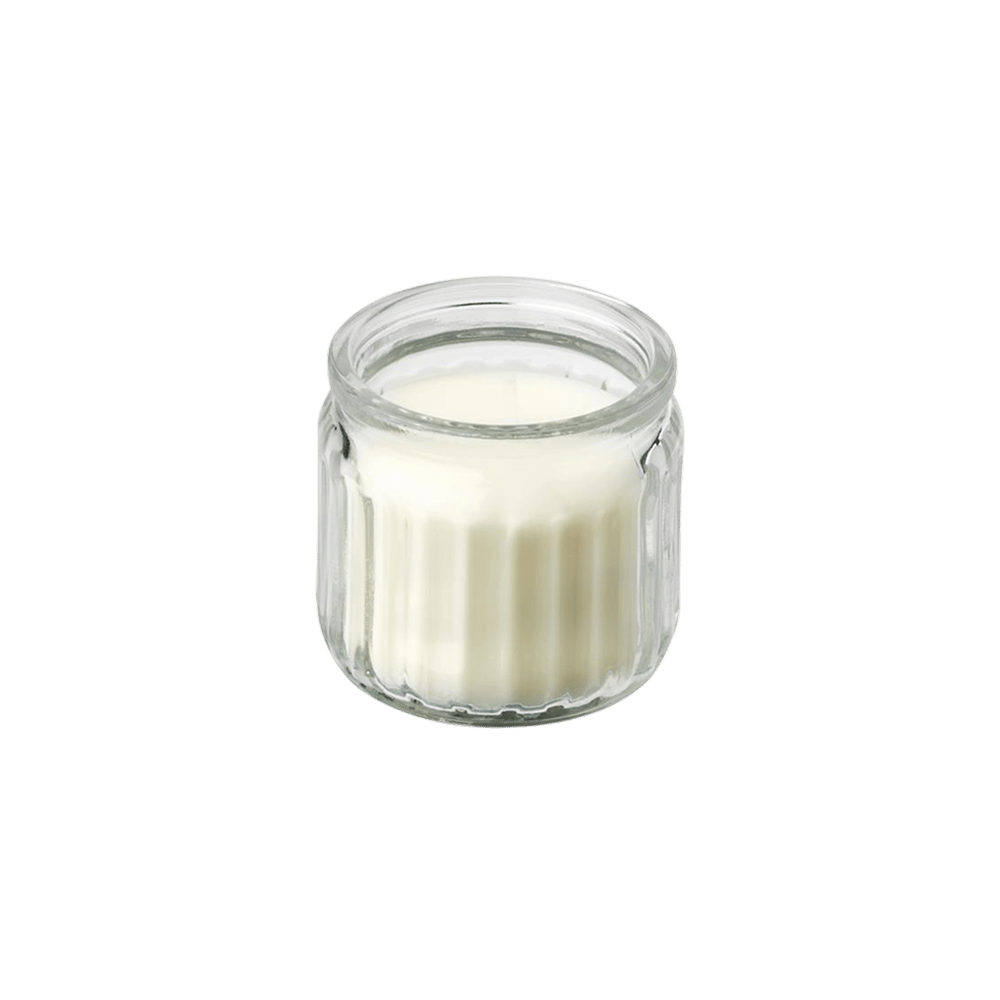 A cutout image of a JÄMLIK vanilla scented candle in a glass jar, with 12 hour burning time.