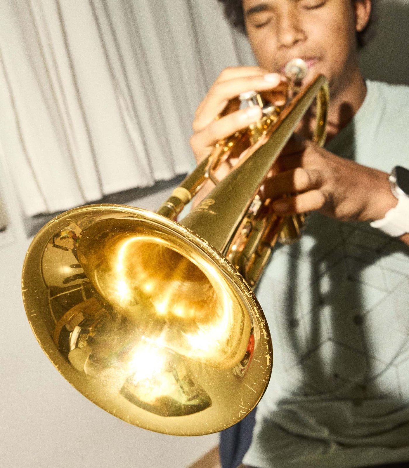 A person playing a trumpet.