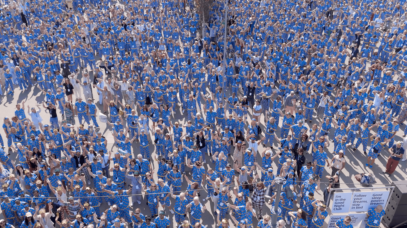 An aerial photo of a crowd of people wearing the same blue pyjamas