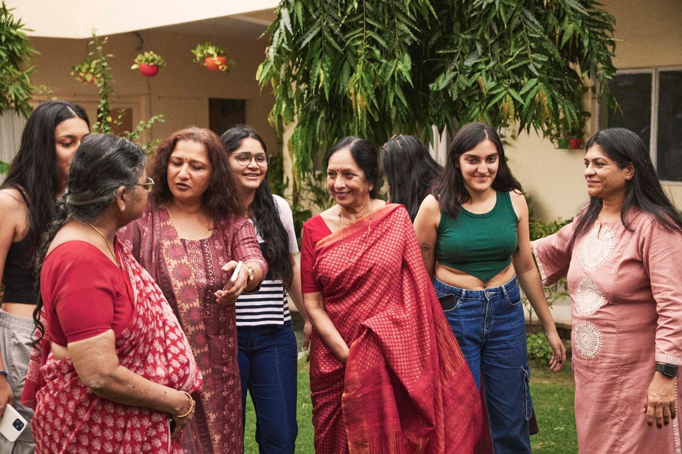 A group of seven women standing outside a house.