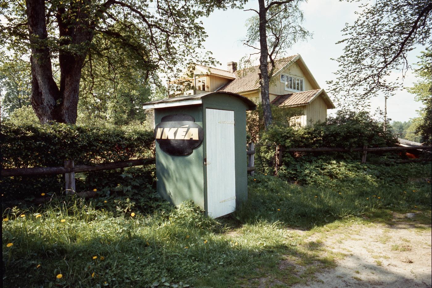 An old image of a green delivery box with an IKEA sign on the side of a country lane.