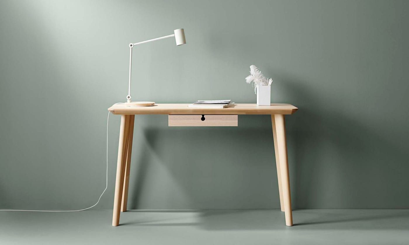 LISABO desk with lamp and pen holder against a green background