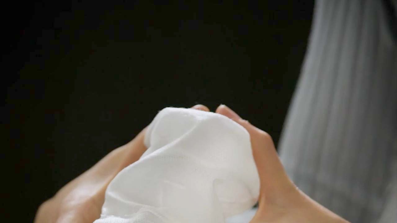 A pair of hands hold a spring