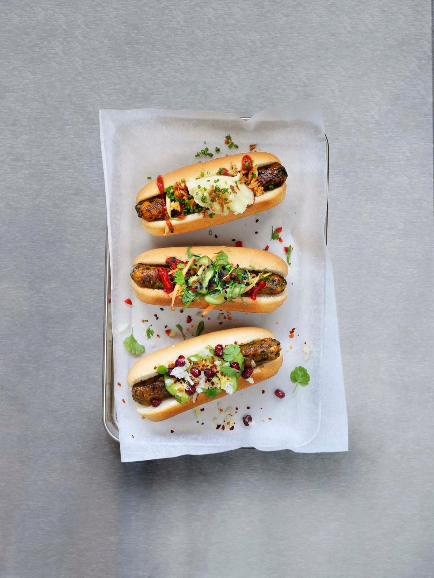 A tray shot from above holding three plant-rich hot dogs.