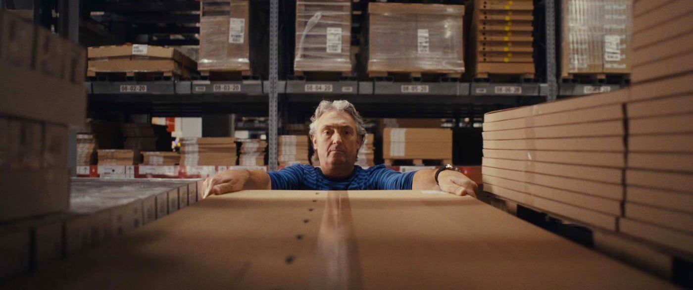 View from an IKEA warehouse shelf as a co-worker removes a box.
