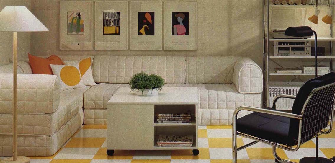 An image from the 1984 IKEA catalogue a yellow and white living room with a quilted corner section.