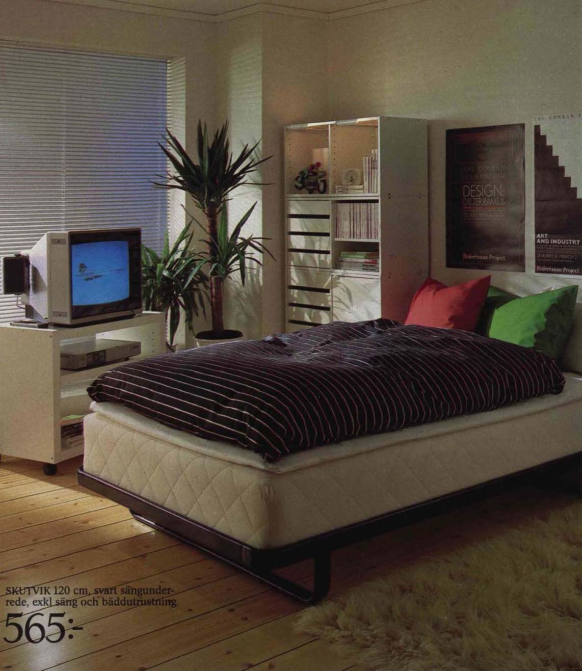 An image from the 1984 IKEA catalogue featuring a bed with a TV and large plant beside it.