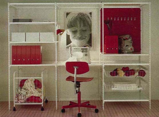A red and white home office area with pictures on the wall.