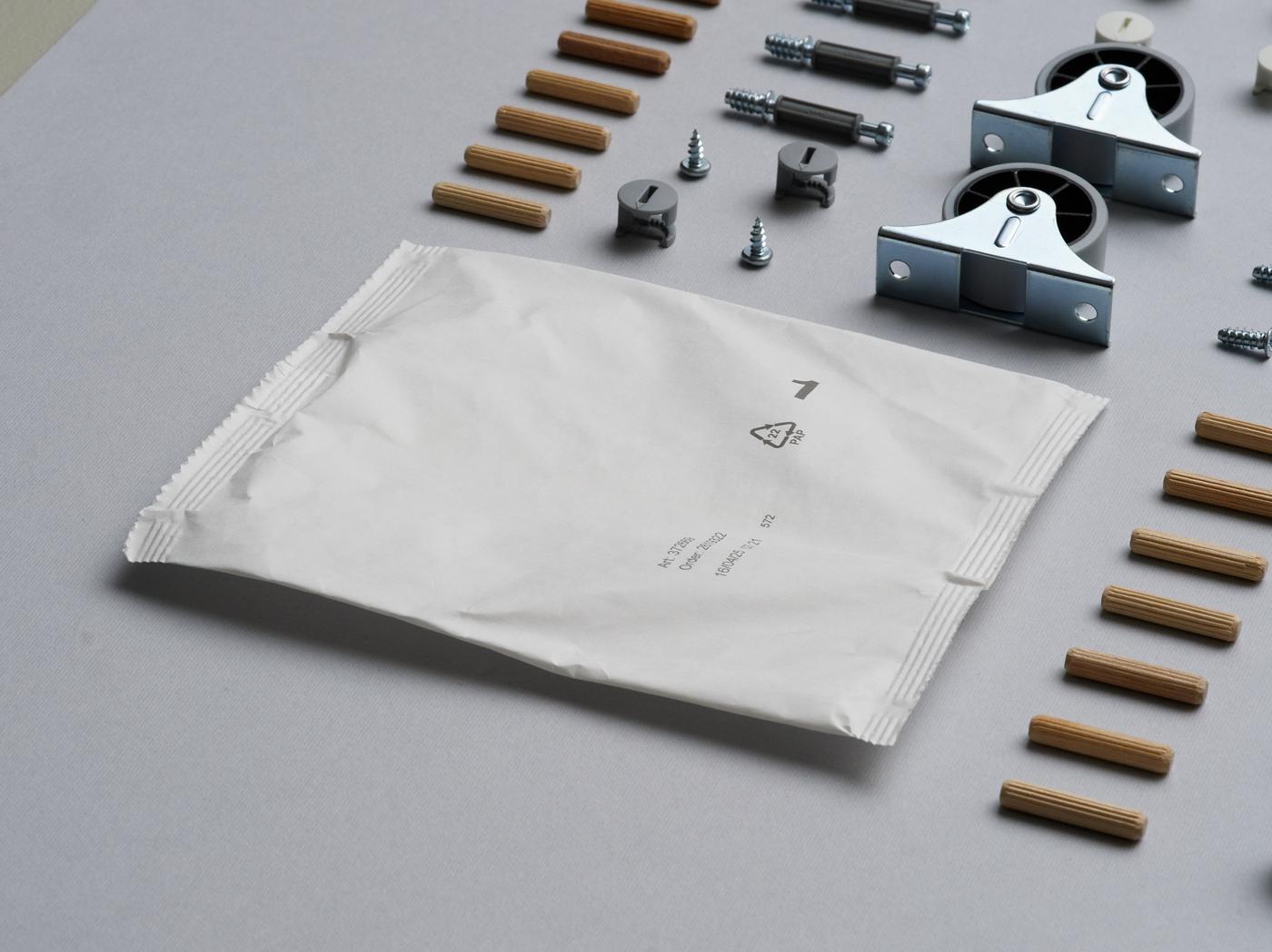 A paper-based bag next to neatly lined up fittings.