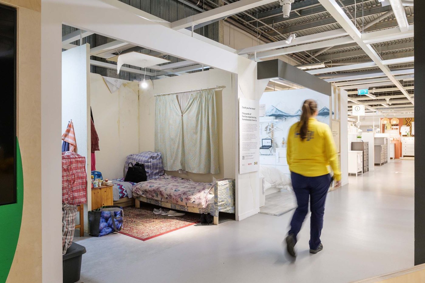 An IKEA co-worker walks past a real life roomset in the Bristol store.