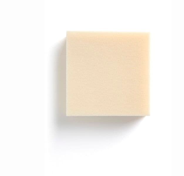 A piece of mattress foam on a white surface.