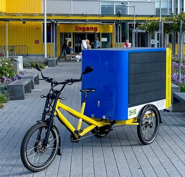 A solar-powered cargo bike parked outside an IKEA store.
