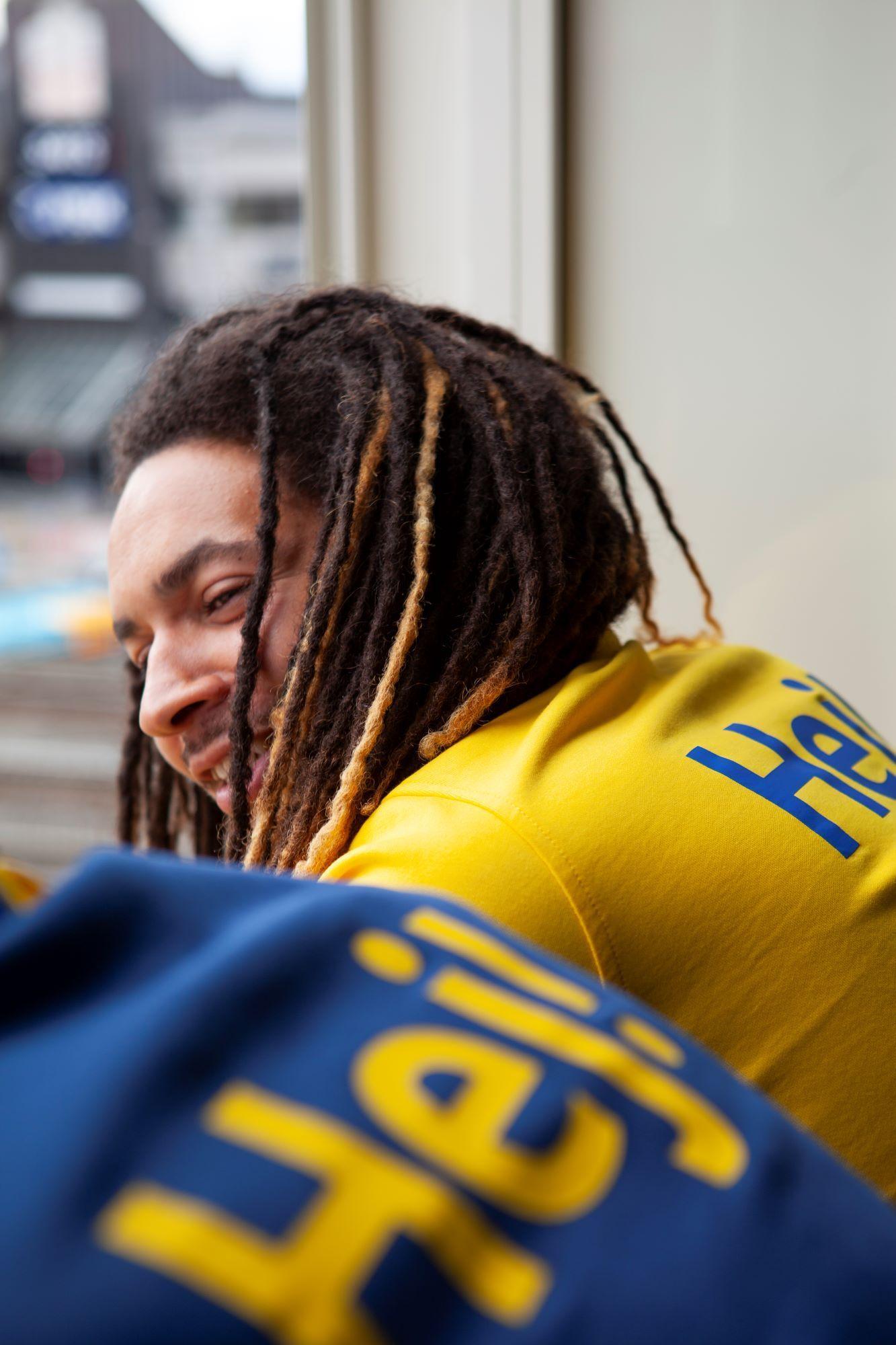 IKEA co-worker laughing in IKEA clothing.