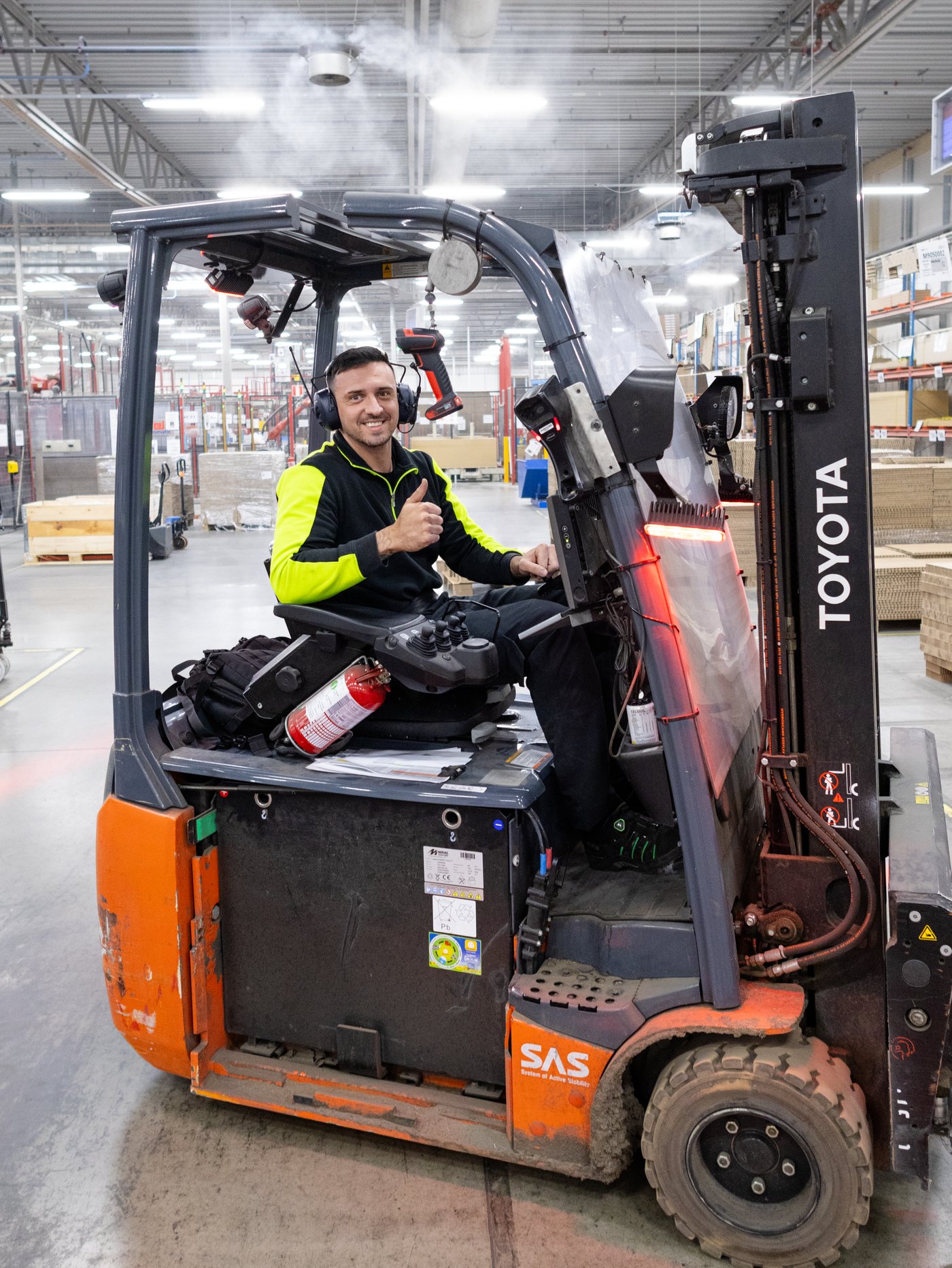 A person driving machinery in a factory.