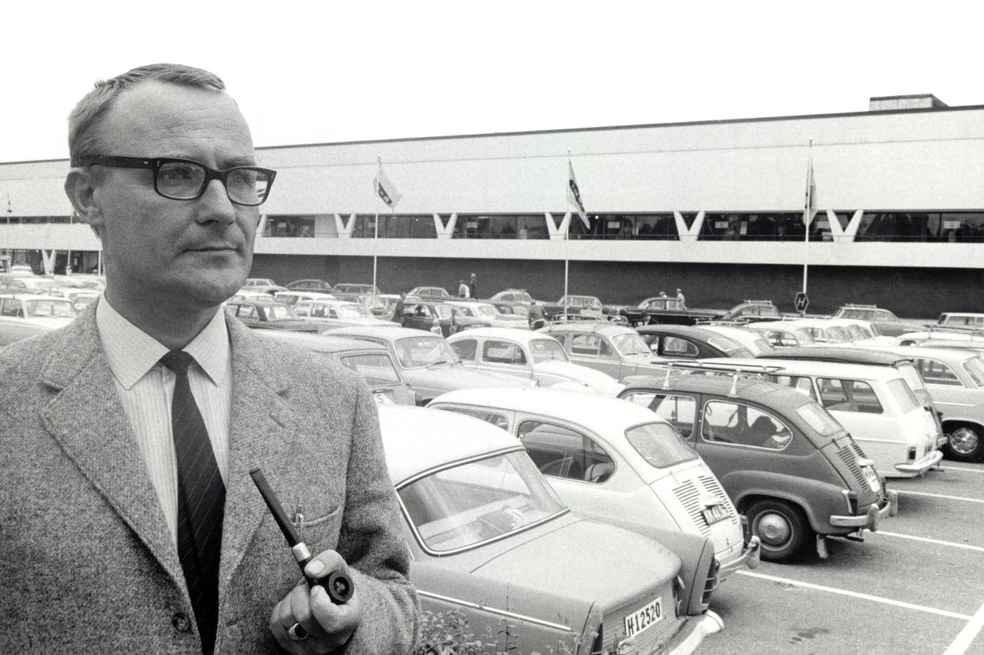Black and white photograph of IKEA founder Ingvar Kamprad outside the first IKEA store in Älmhult.