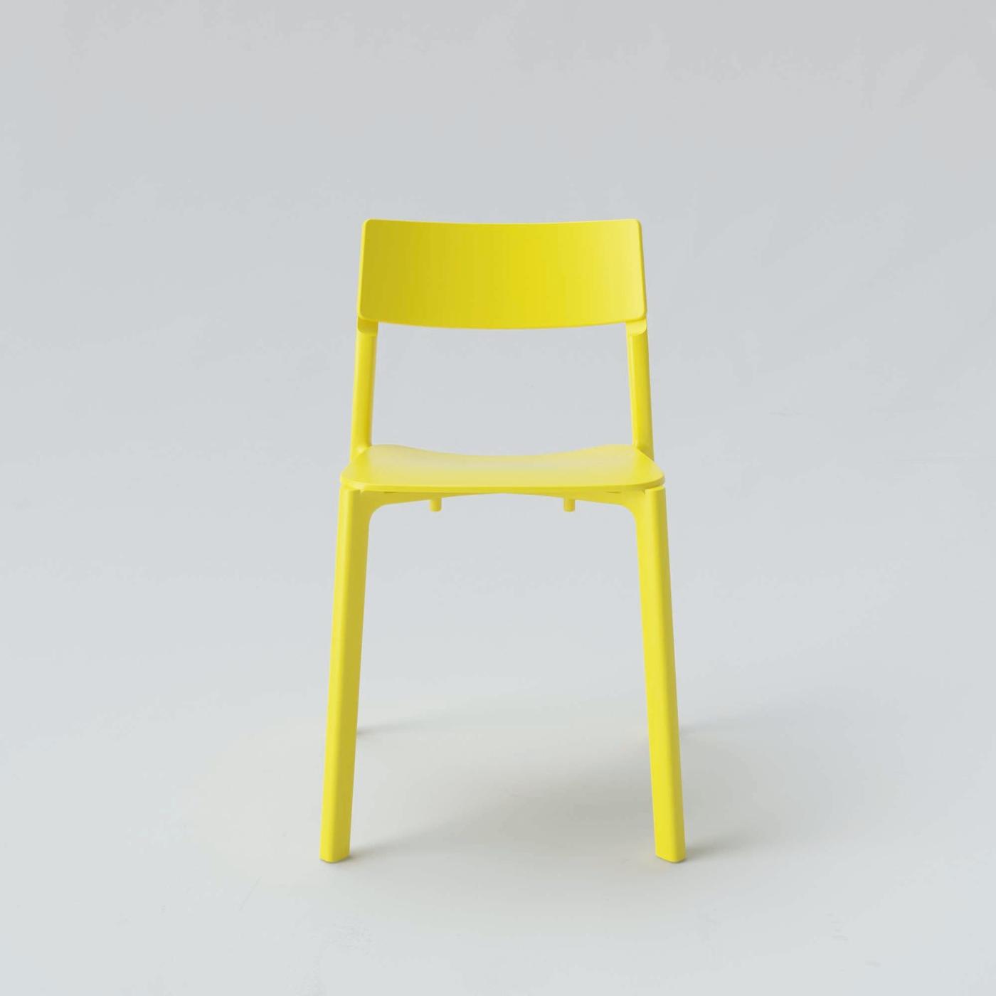 A bright yellow JANINGE dining chair.