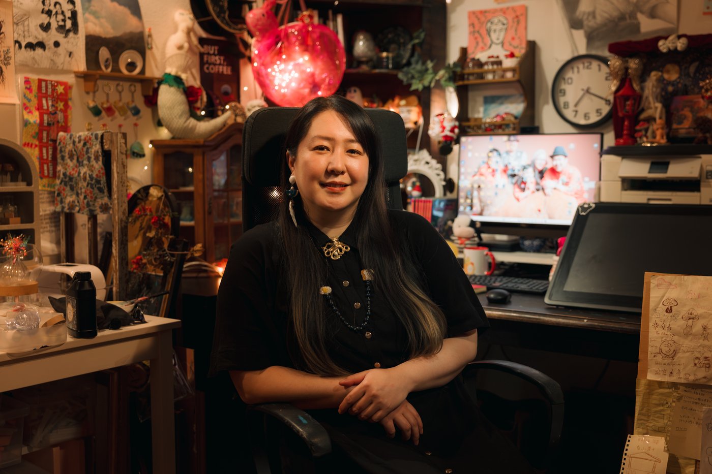 A person sitting and looking at the camera in a room full of memorabilia.