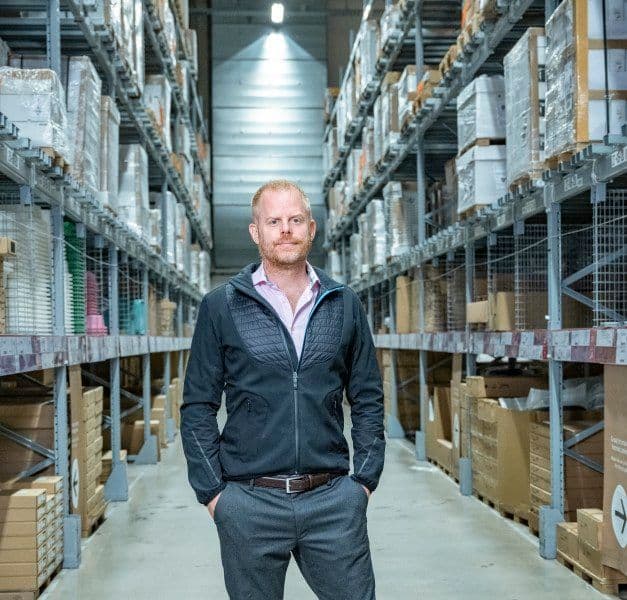 A man standing in an isle at an IKEA store.