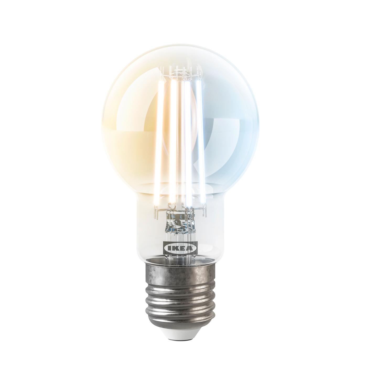 Lit clear glass decorative bulb shown against a transparent background.