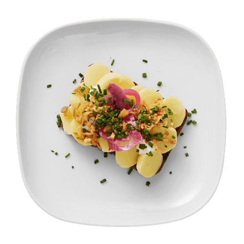 An open-faced potato sandwich on a plate.