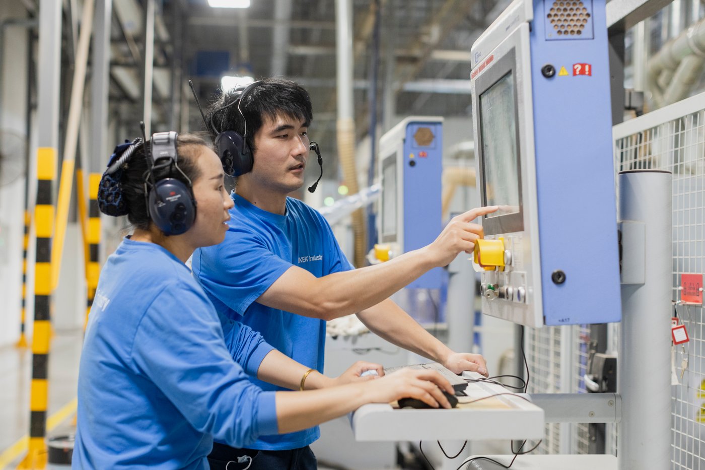 Two people look at a screen in the Nantong factory.