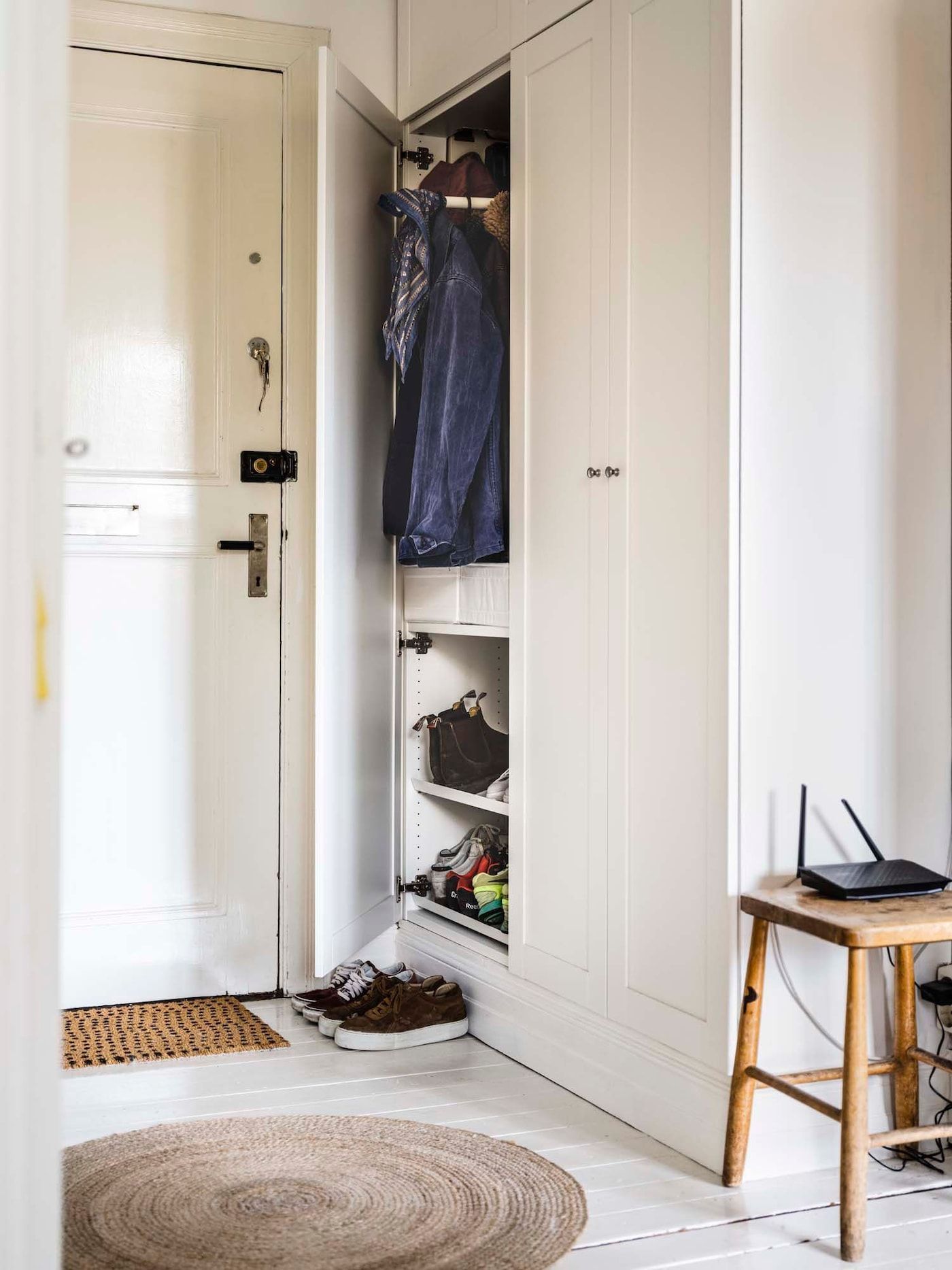 A wardrobe in a small hallway, with one door partially open.