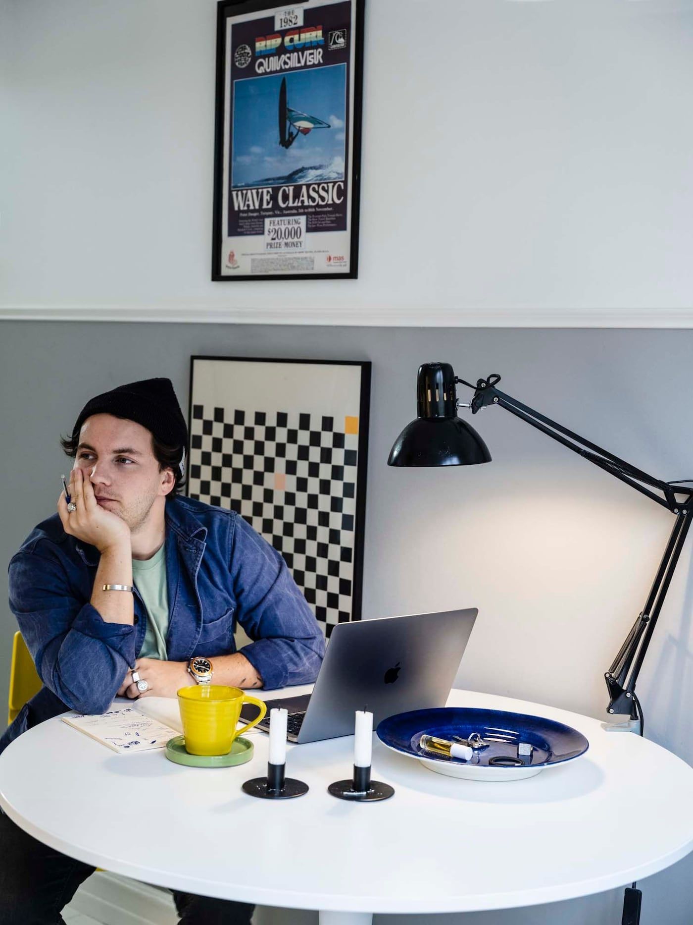 Linus sits with his laptop at a round, white table.