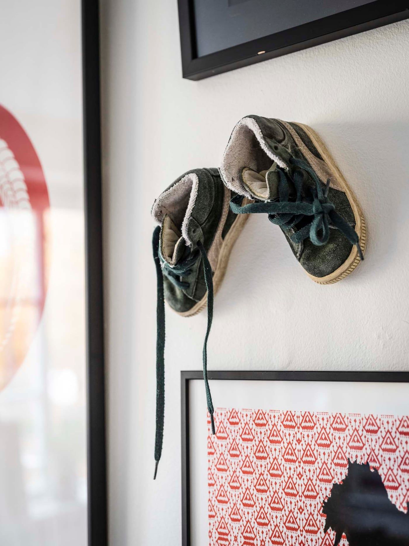 Baby shoes displayed on a wall as ornaments.