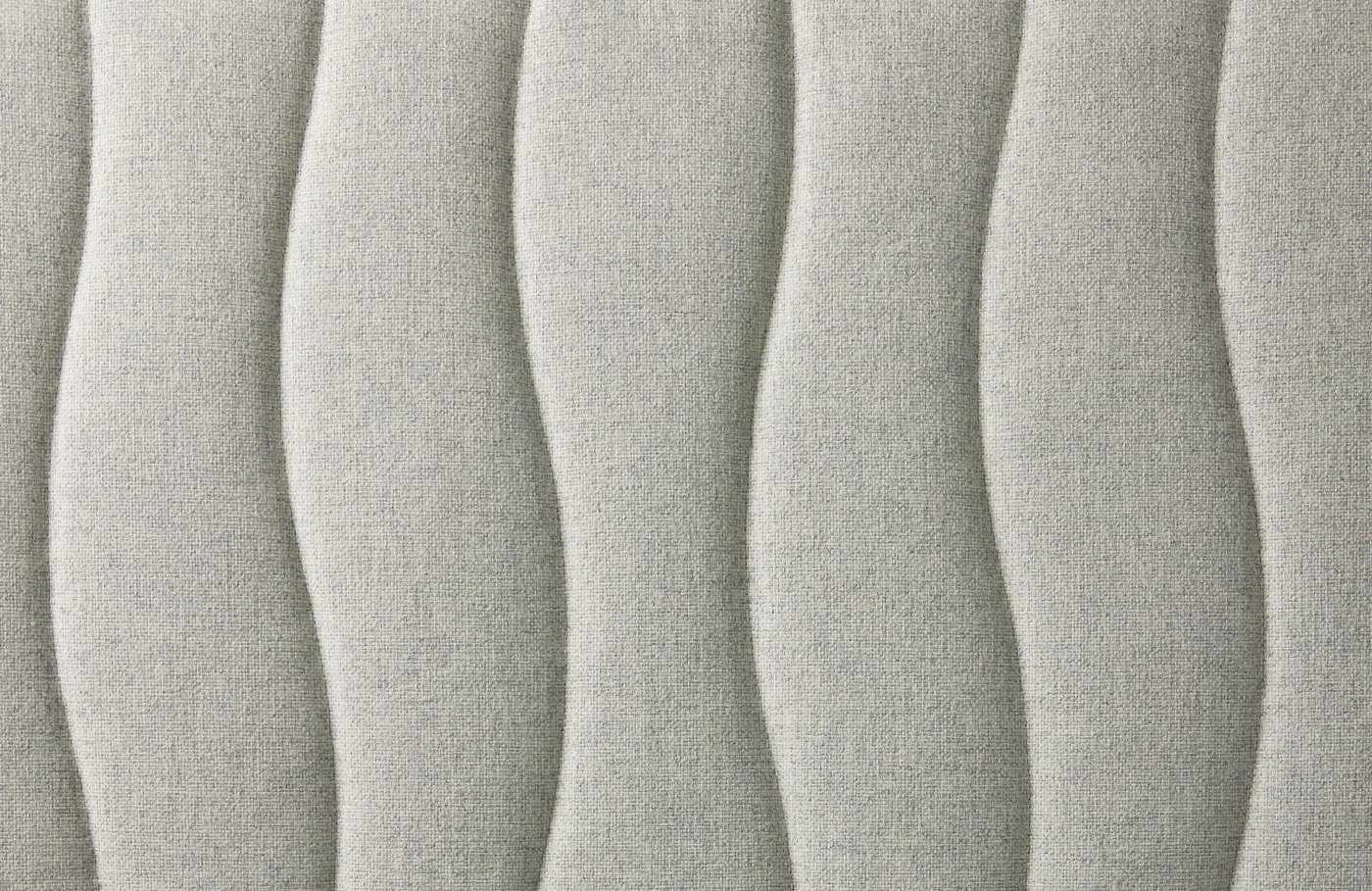 A close-up on the fabric of a gunnared beige MITTZON acoustic screen for desk.