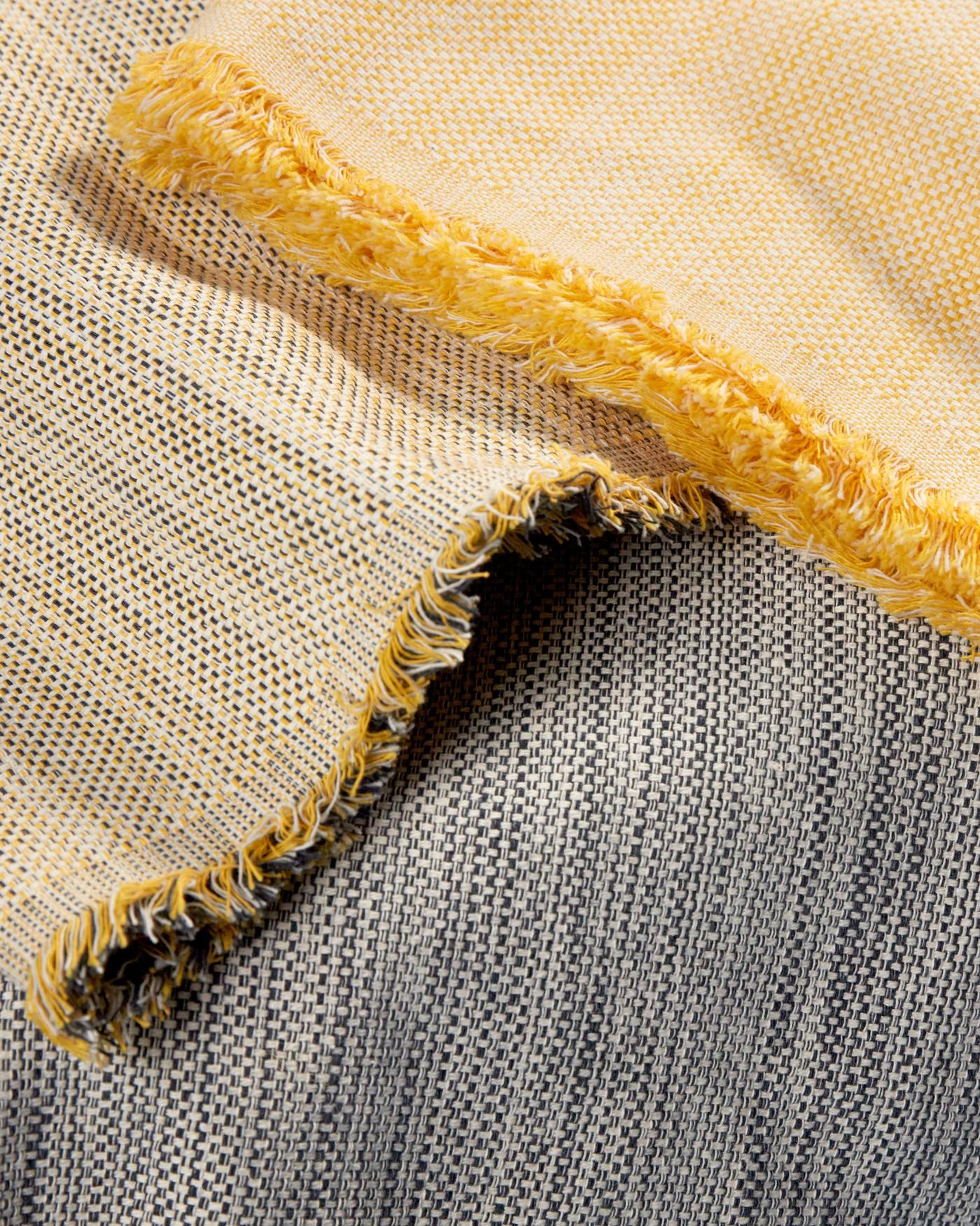 Different fabrics of the VÄXELBRUK collection in grey to yellow tones.