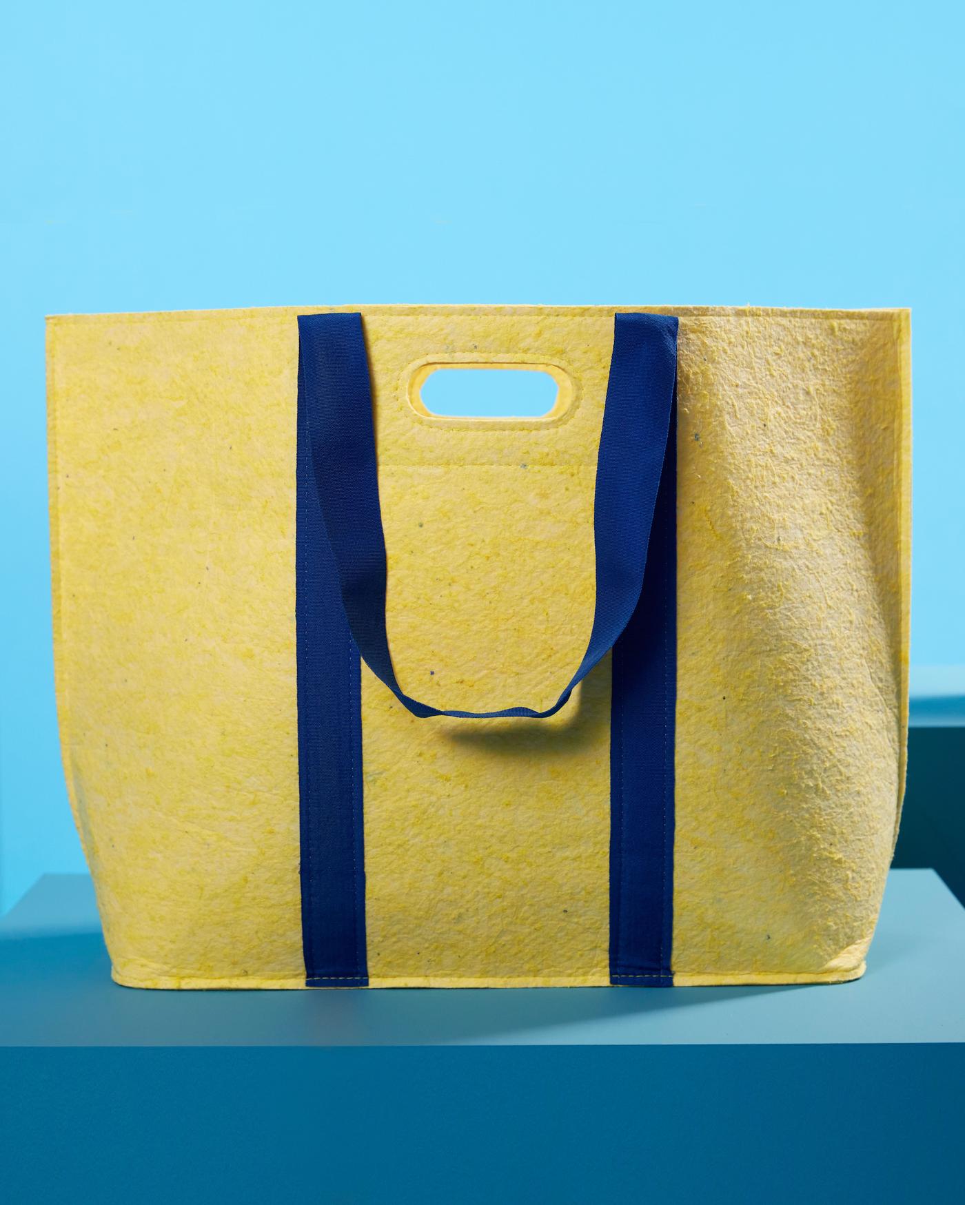 A yellow and blue textile bag from the VÄXELBRUK collection.
