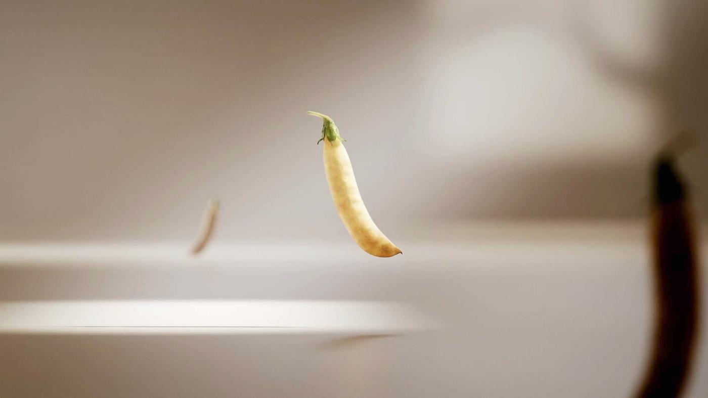 Peas float in thin air. The film is about the making of plant balls, the taste and texture.