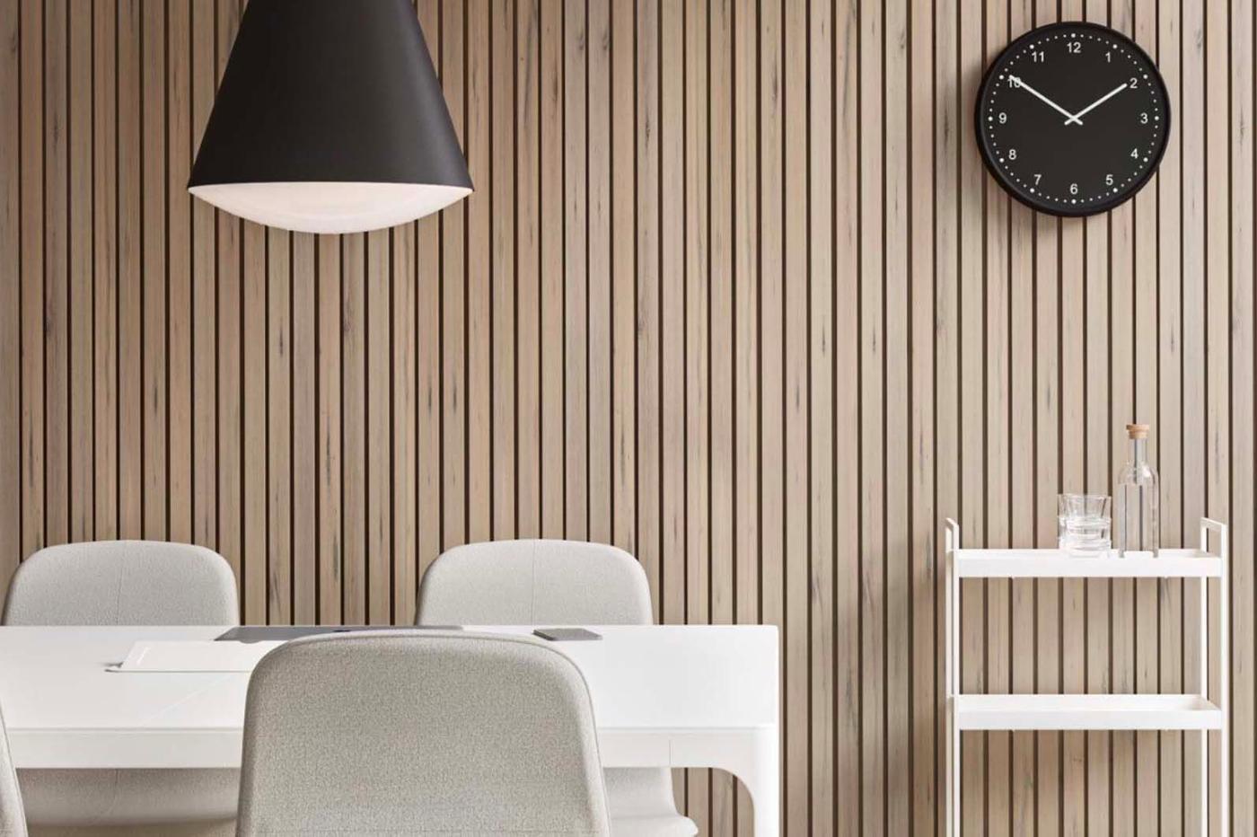 An office space with pre-loved table and chairs, trolley and a wall clock.