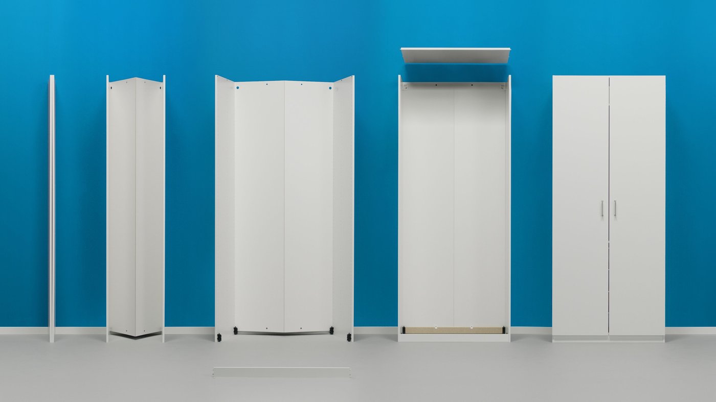A group of white PAX wardrobes in different stages of assembly, against a bright turquoise background.