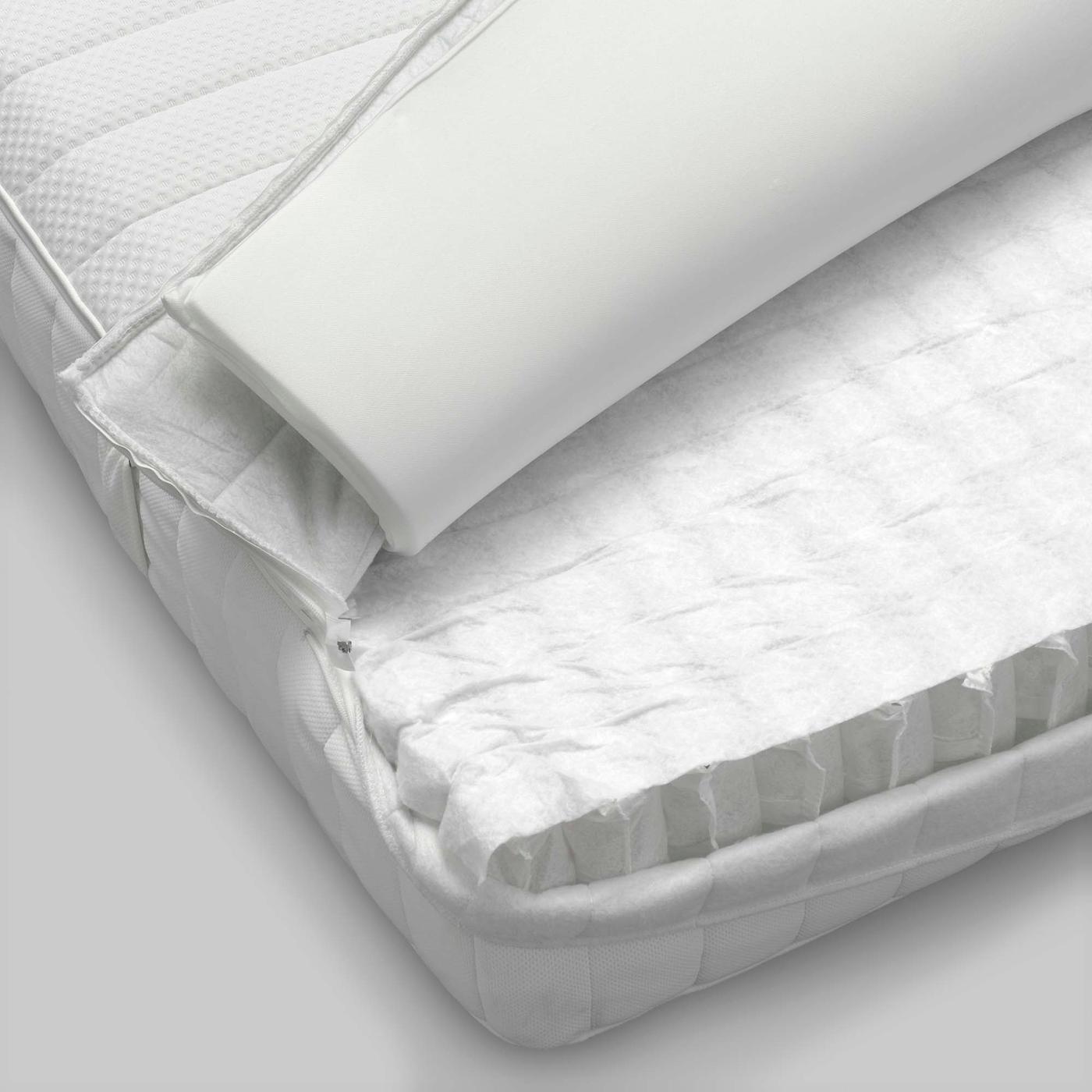 A close-up of an opened mattress, revealing the inner foam content.