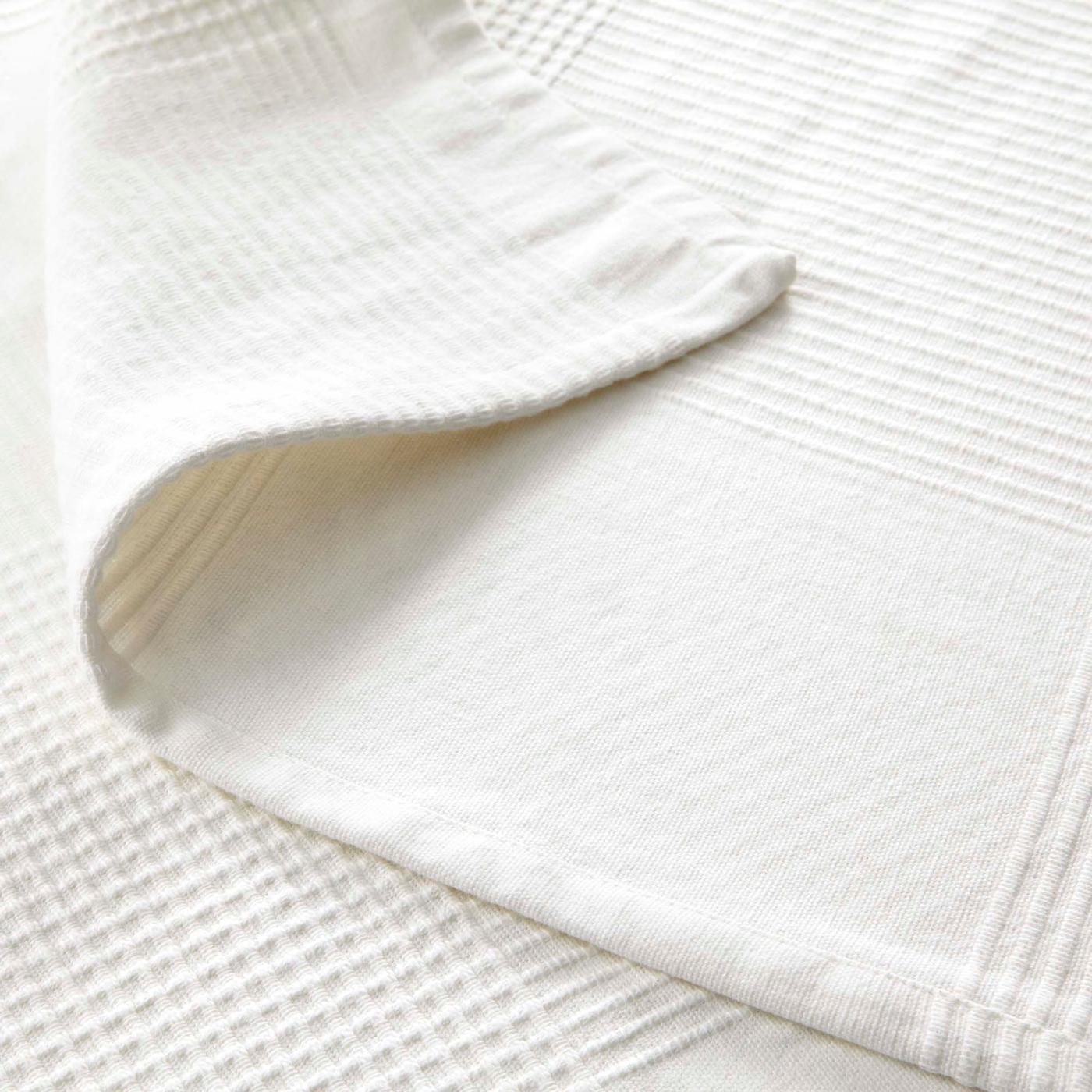 A white cotton towel with the edge turned over.