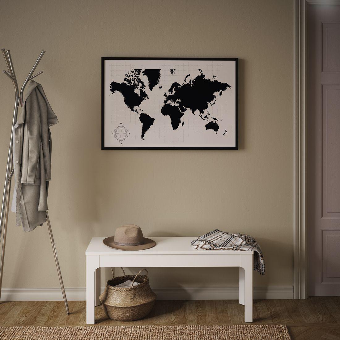 A hallway with a world map BILD poster on a beige wall above a white bench with a coat stand to the left.