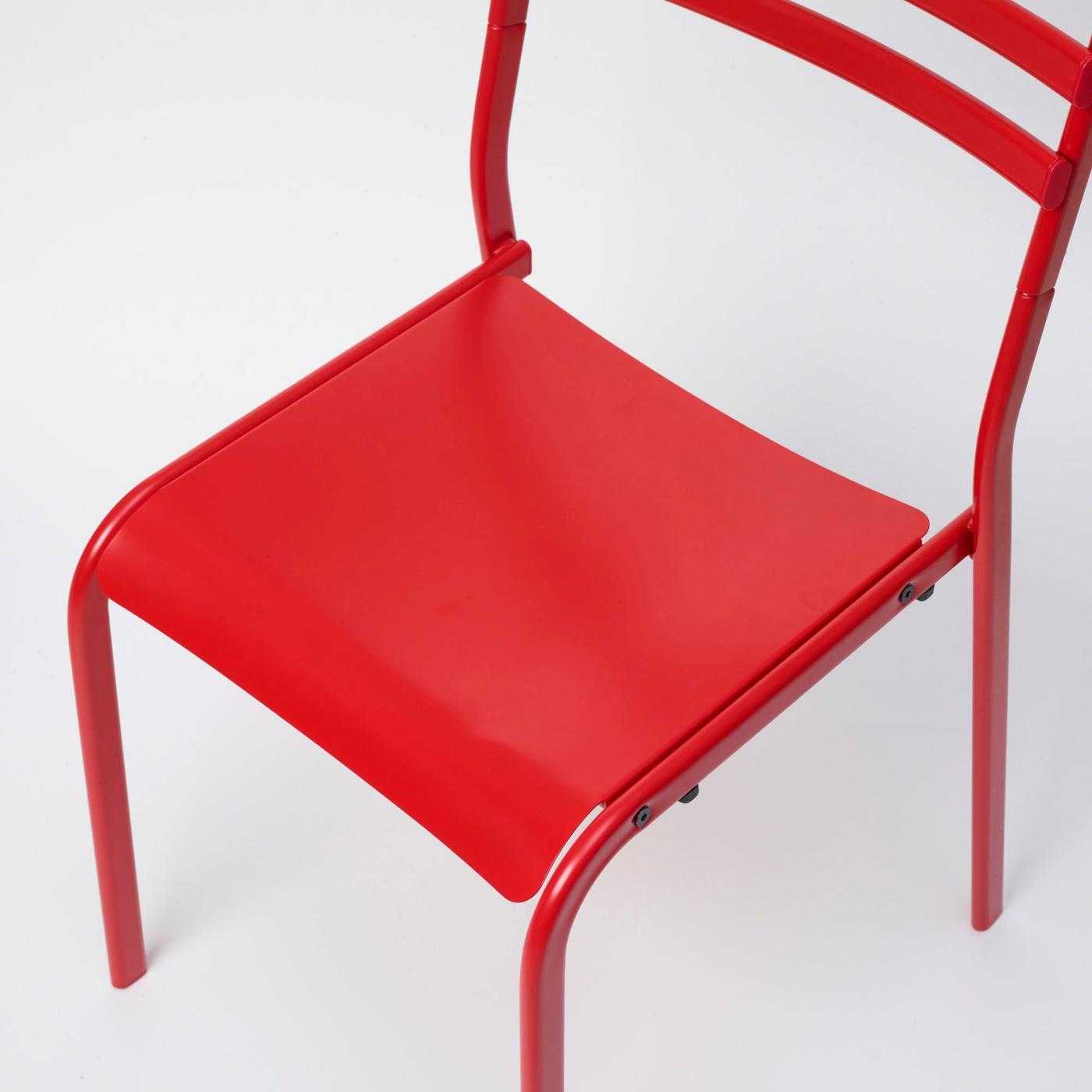 Elevated, downward-looking view of a red GENESÖN chair on a white background.