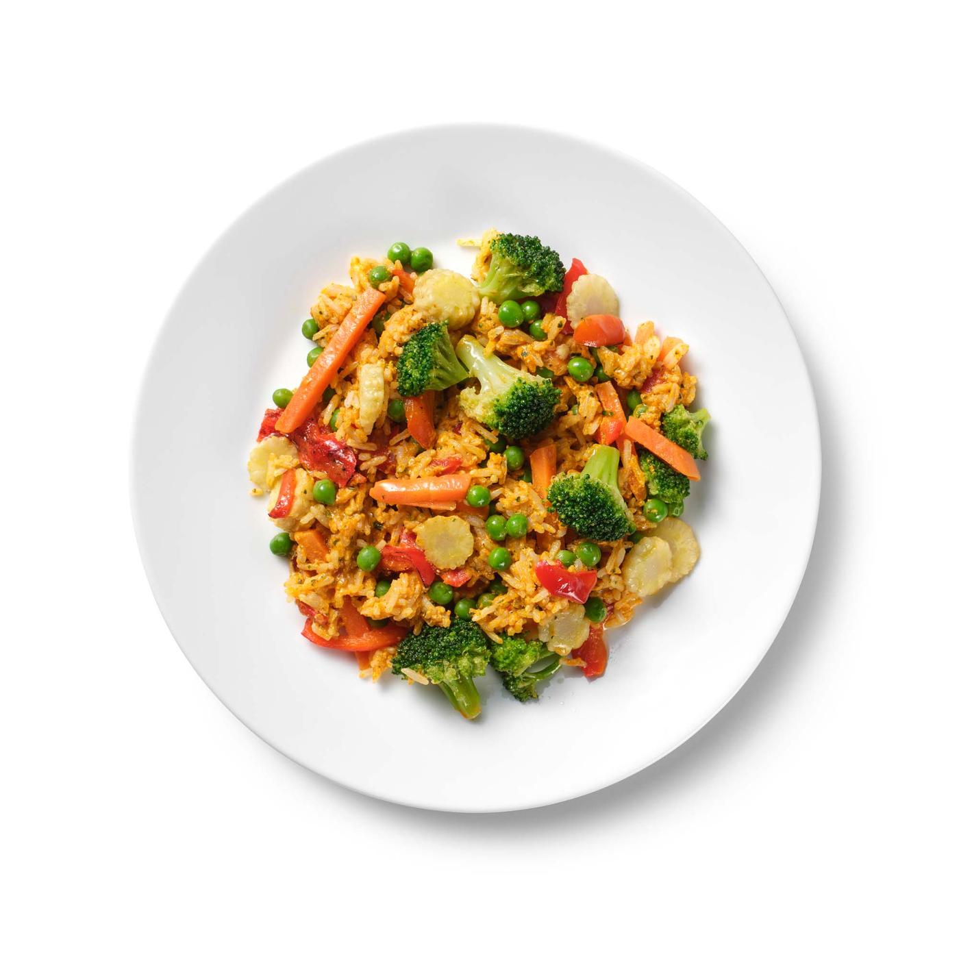 A plate of a colourful mix of vegetables and rice. 