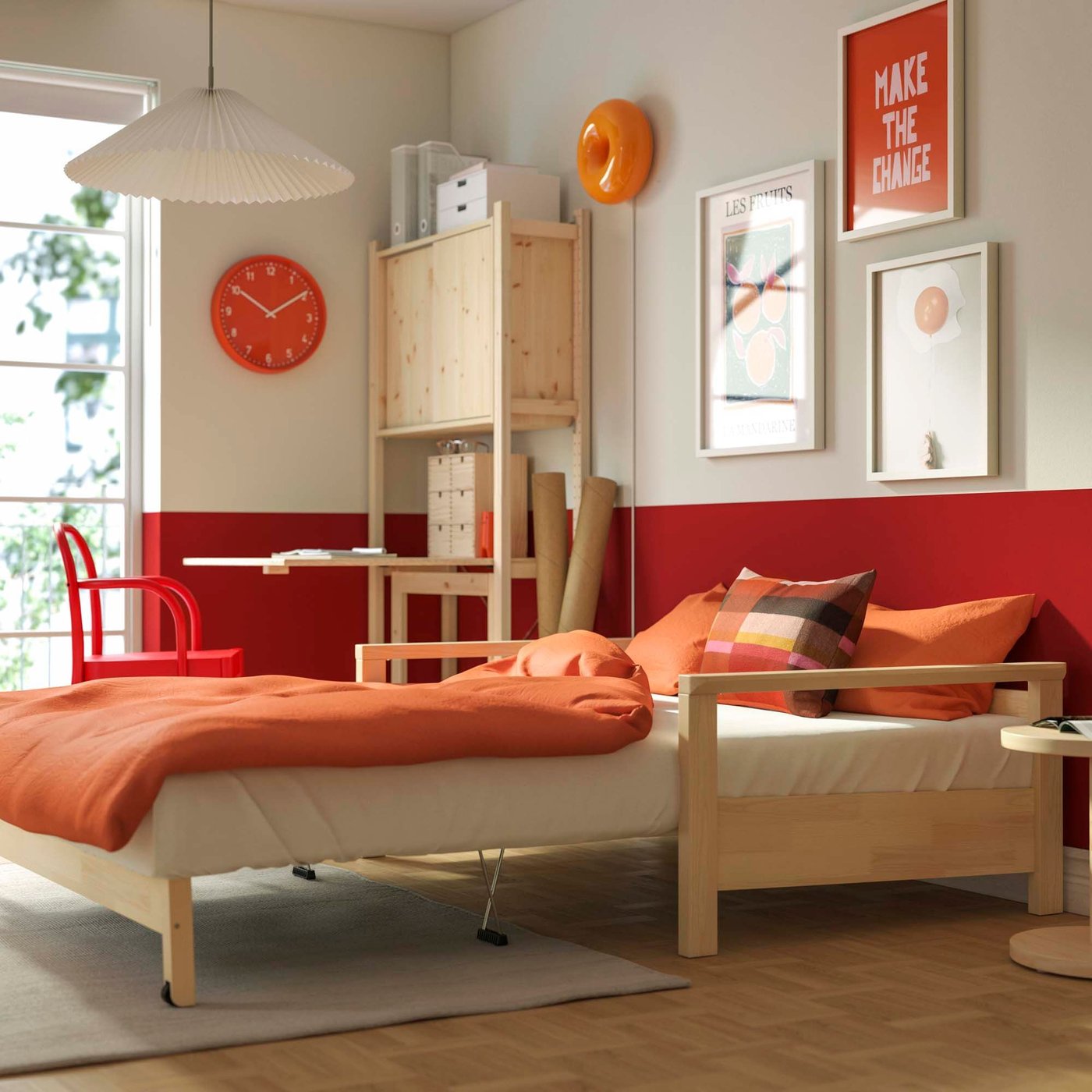 A sofa bed with a wood frame opened out into a bed with orange bed linen.