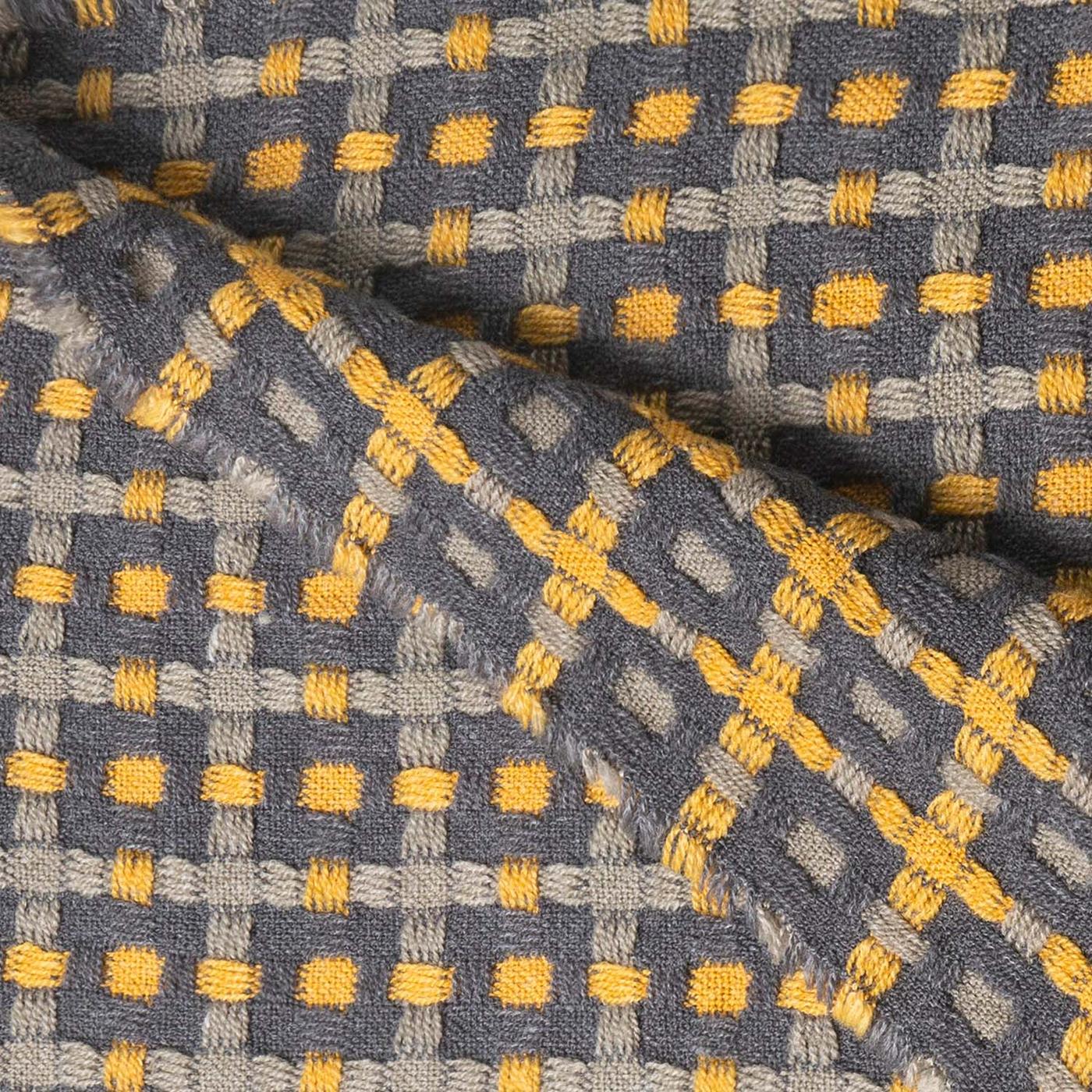 A close-up of a grey and yellow throw.