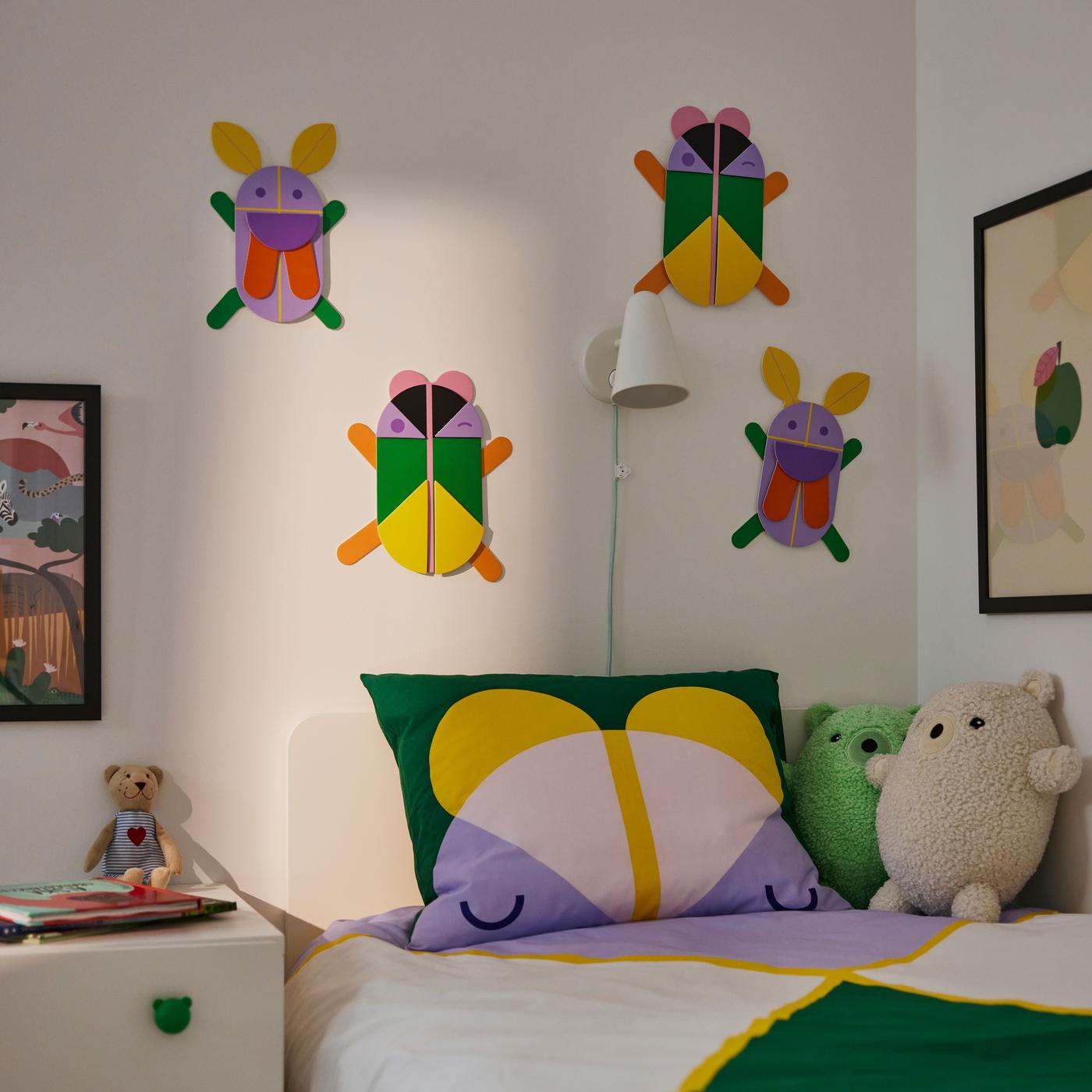 A wall decorated with colorful pieces above a green and yellow rug.