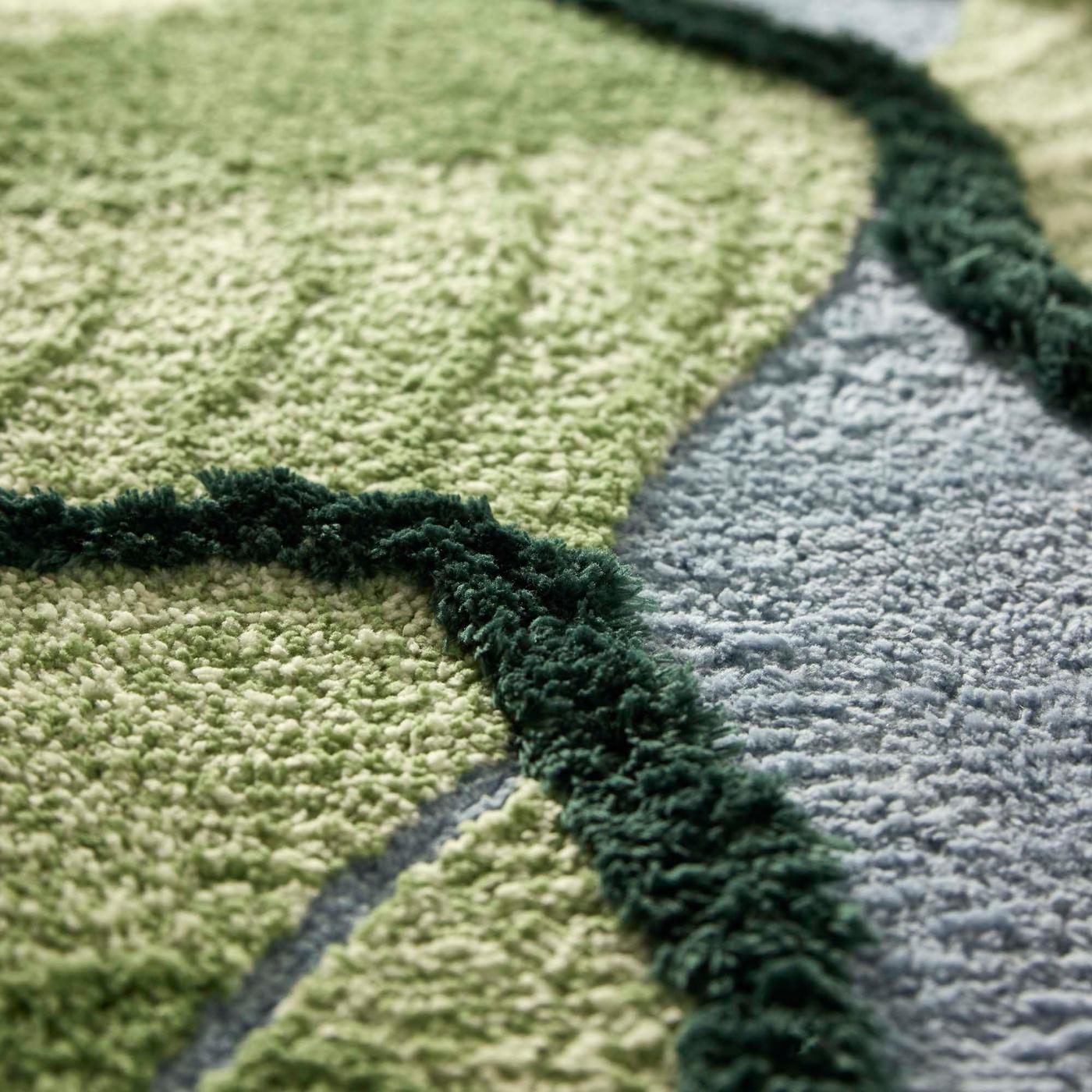 A close-up on a green and grey rug.