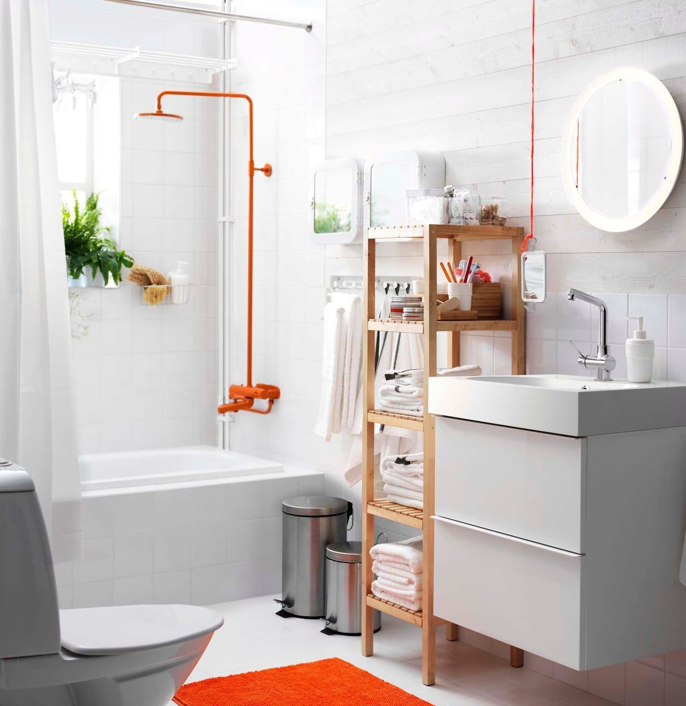 An orange and white bathroom with plenty of shelves and storage.