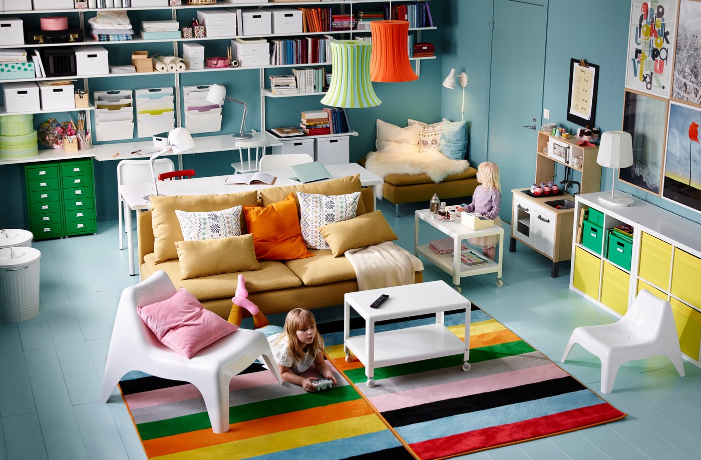 A blue room with a brightly coloured striped rug, an orange sofa, and lots of other colourful pieces.