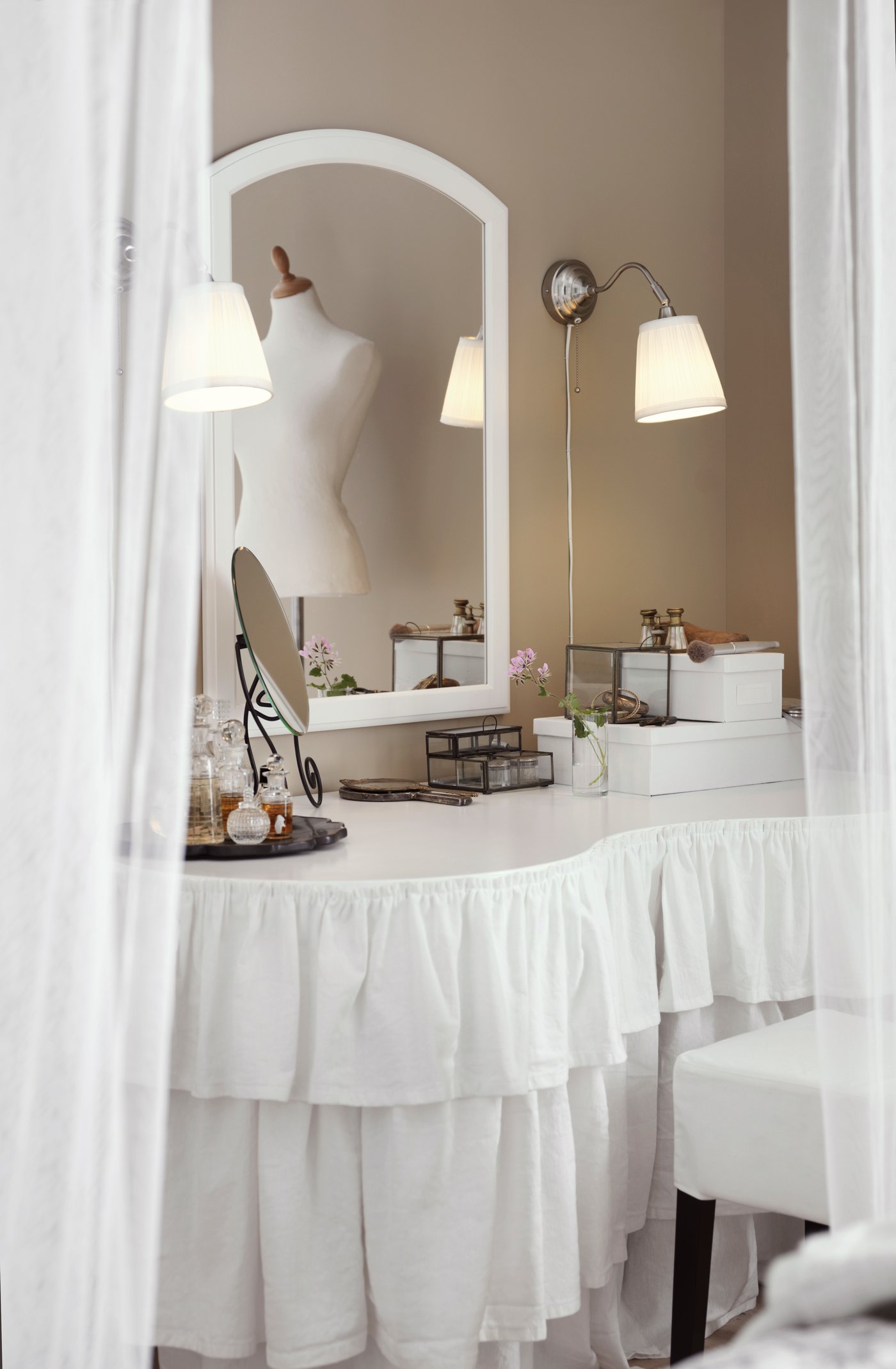 A white dressing table with fabric frills around the edges, from the 2016 IKEA catalogue.