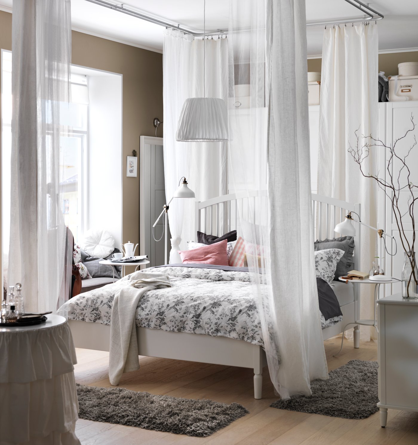 A page from the 2016 IKEA catalogue featuring a four-poster bed in a light bedroom.