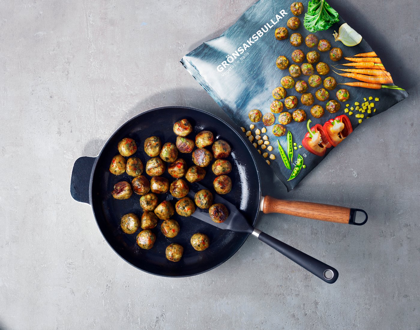 An aerial view of a pan of IKEA vegetable balls, next to an open packet.