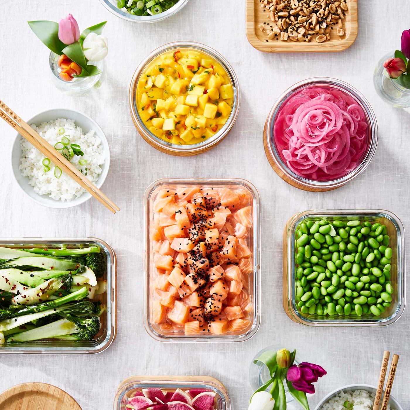 An aerial shot of different open food containers and bowls filled with food.